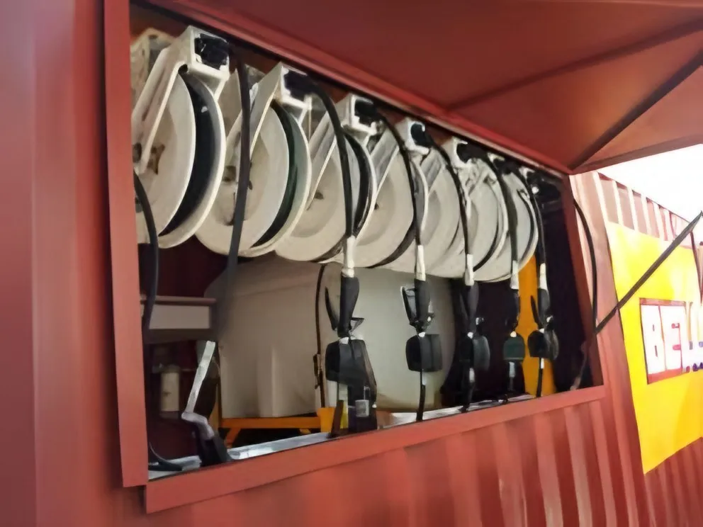 Hose reels mounted inside a mobile lube container